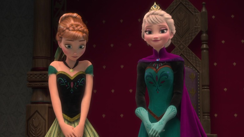 Anna and Elsa standing together while at court in Frozen