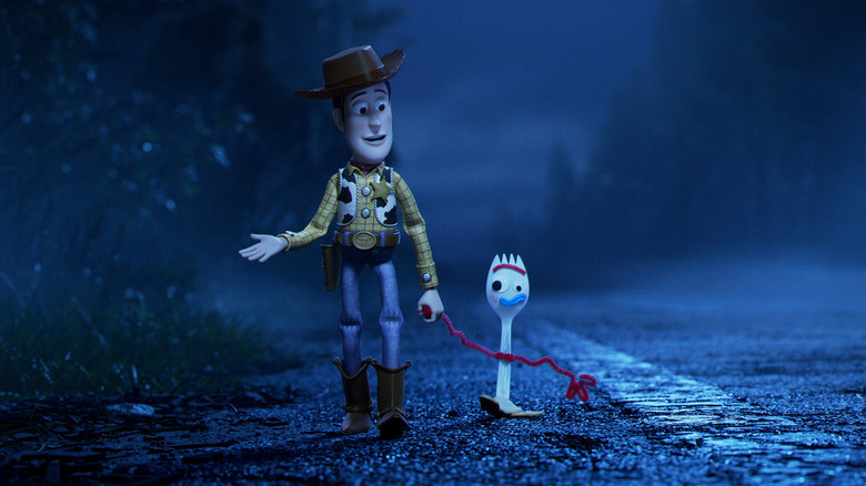 Woody and Forky walk down a dark road together in Toy Story 4