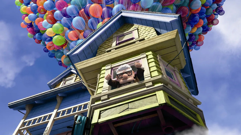 Carl cheers out his window as balloons carry his house into the sky in Up