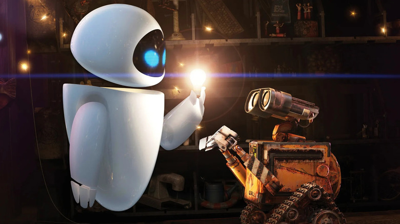 EVE lights up one of WALL·E's lightbulbs as he watches in WALL·E