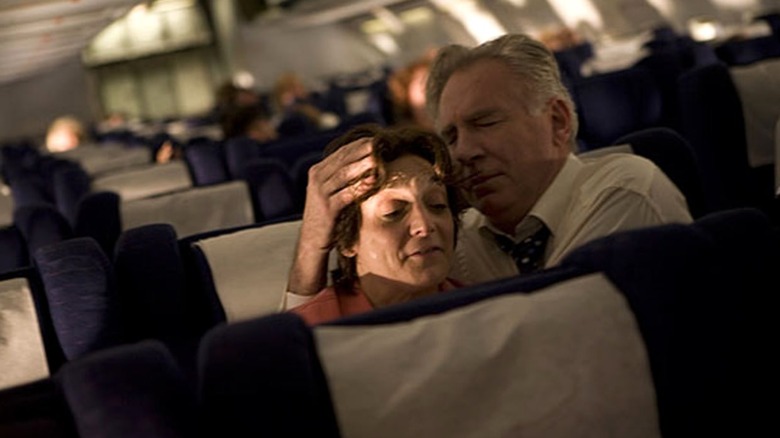 older couple embraces on plane United 93