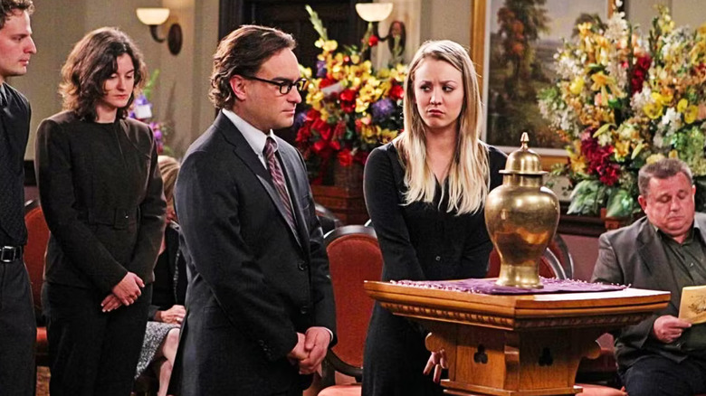 Penny glaring at Leonard at Professor Proton's funeral on The Big Bang Theory