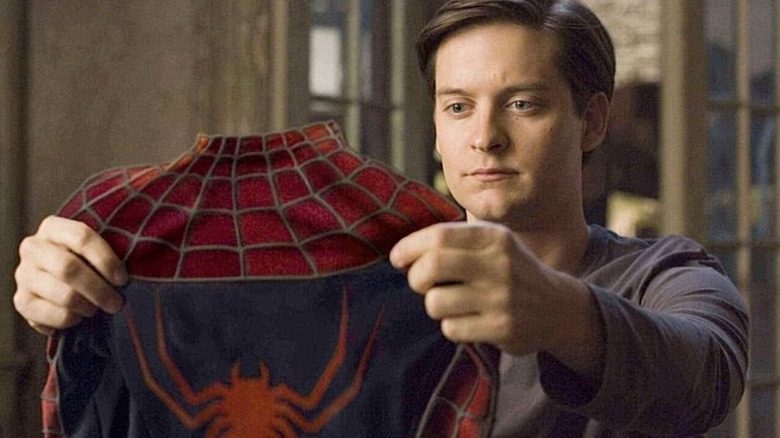 Peter Parker holds his new suit 
