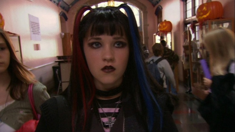 Cassie Keller (Emily Osment) walking down a school hallway in The Haunting Hour movie