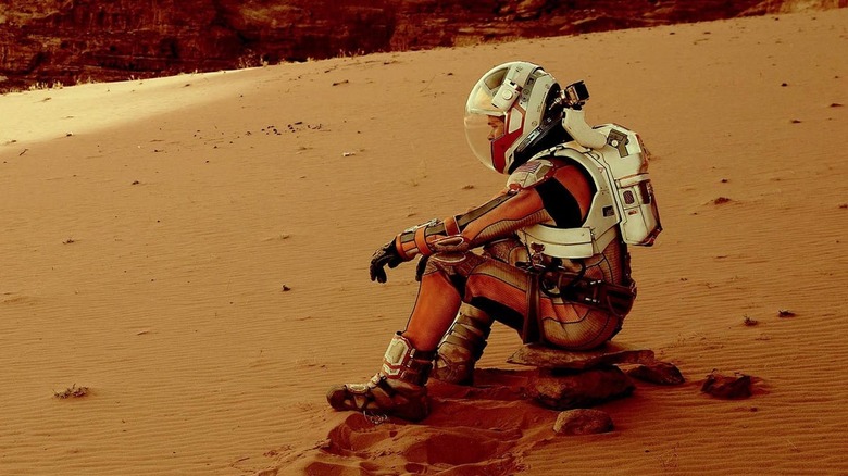 Matt Damon sitting on Mars dune