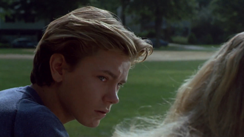 Danny (River Phoenix) looking at Lorna (Martha Plimpton) with tears in his eyes in Running on Empty