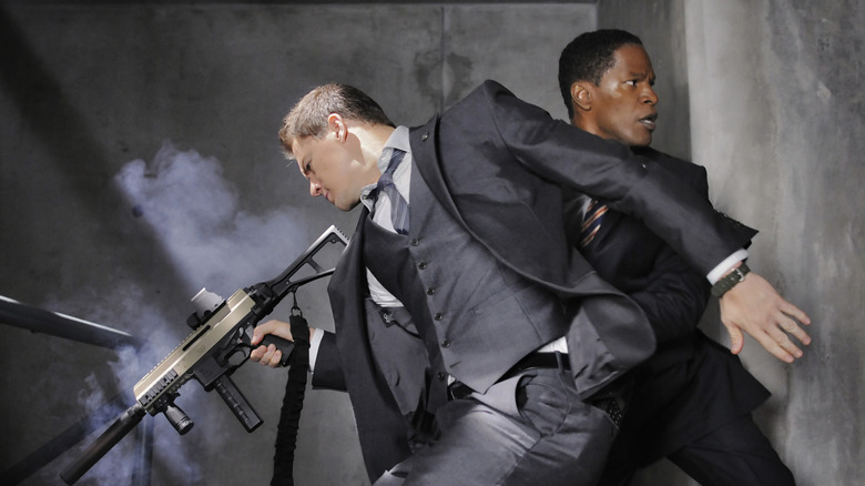 Two men in suits, with guns