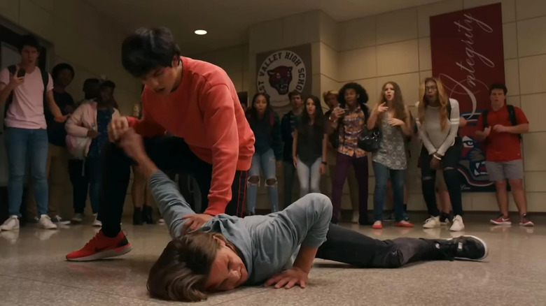 Miguel grabs Robby's arm and nearly breaks it in Cobra Kai