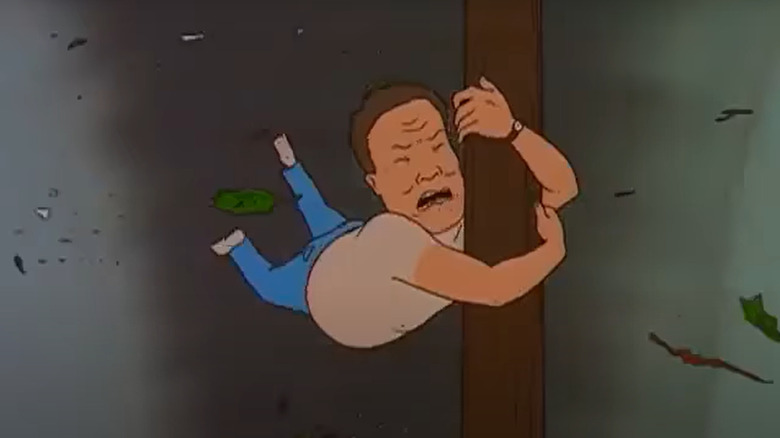 Hank holding onto telephone poll