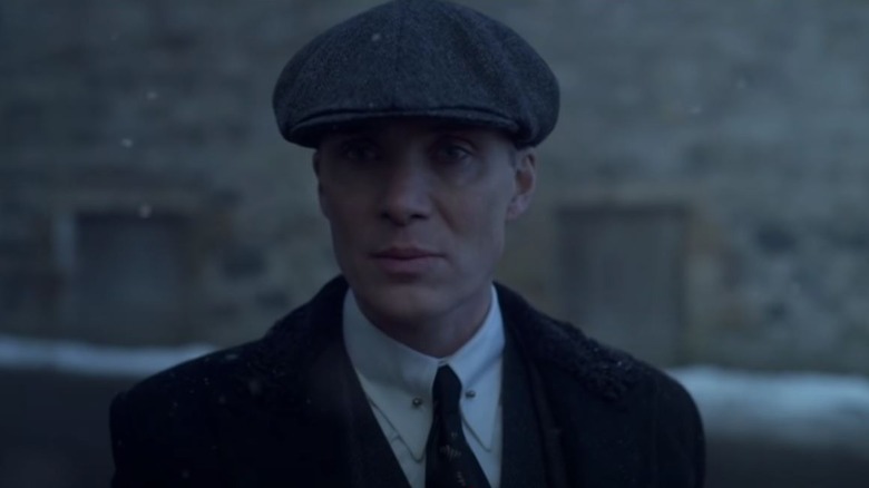 Cillian Murphy's Tommy Shelby wearing a suit and a cap on Peaky Blinders