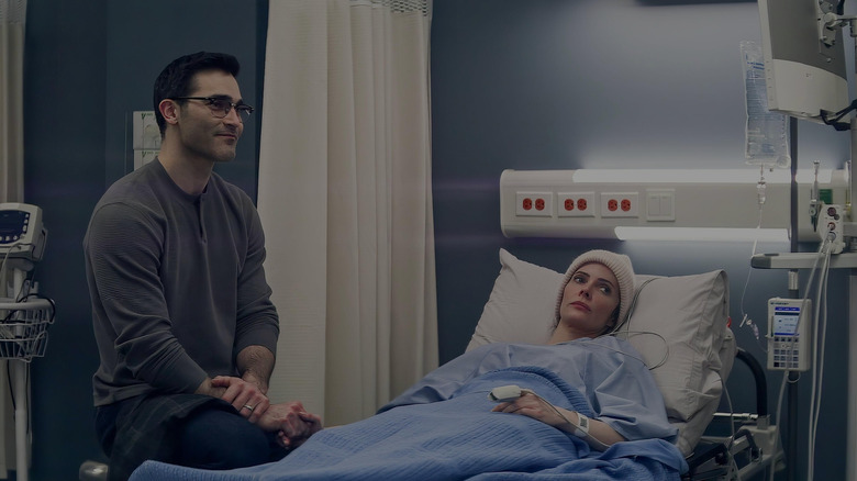 Superman sitting next to Lois who is lying in a hospital bed in Superman & Lois