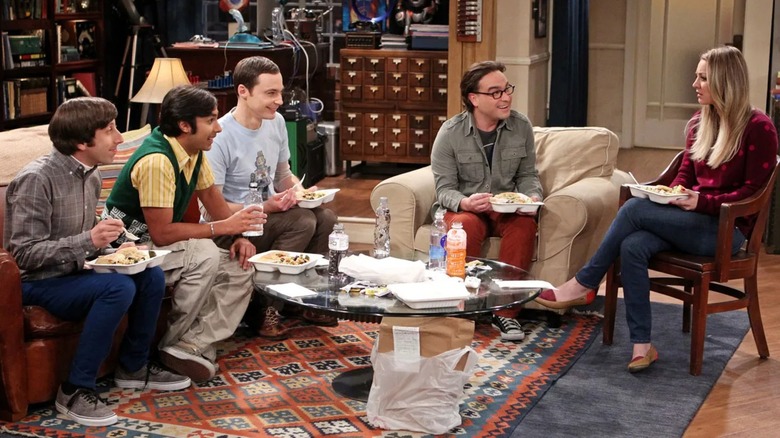 Howard Rah Sheldon Leonard and Penny eating dinner in the living room on The Big Bang Theory