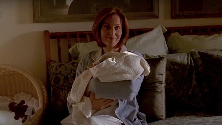 Scully holding baby