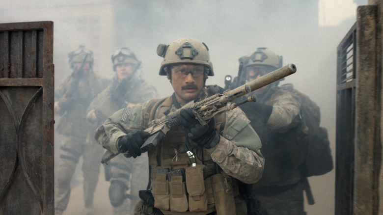 Navy SEALs brandishing long-rifles storm a compound in Warfare