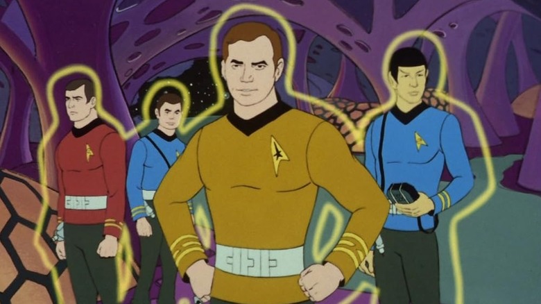 Kirk (William Shatner) leads the landing party with their forcefields active in Star Trek: The Animated Series