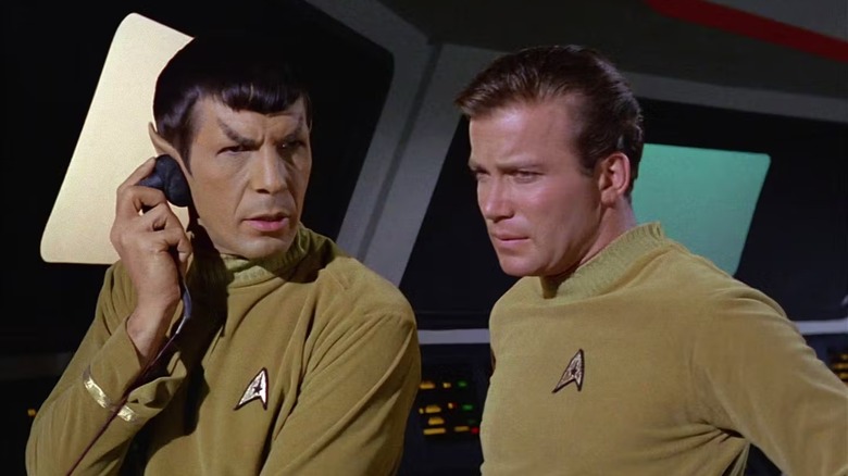 Spock (Leonard Nimoy) listens to signals next to Kirk (William Shatner) in Star Trek: The Original Series