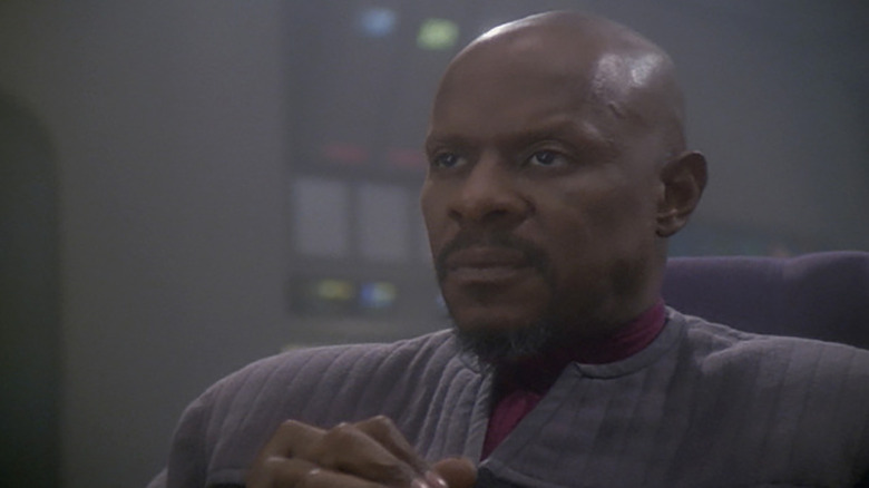 Benjamin Sisko (Avery Brooks) looks gravely ahead in Star Trek: Deep Space Nine