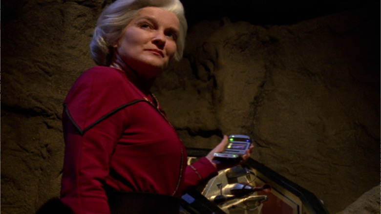 An older Kathryn Janeway (Kate Mulgrew) monitors a device in Star Trek: Voyager