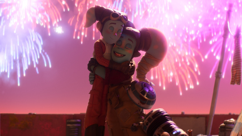 Anni and Kalina hugging against fireworks