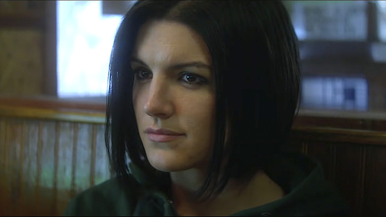 Gina Carano sits in diner booth in Haywire