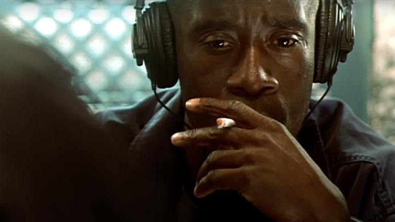 Don Cheadle in Traffic wearing headphones and smoking