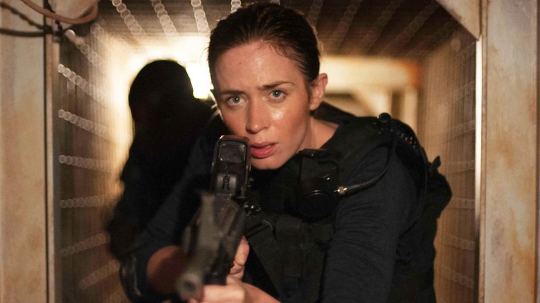 Kate Macer walking through a doorway in Sicario