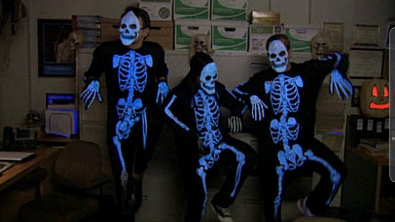 Three Office employees dressed as skeletons