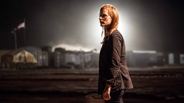 Jessica Chastain's Maya looks haunted, backlit by a strong light, in Zero Dark Thirty