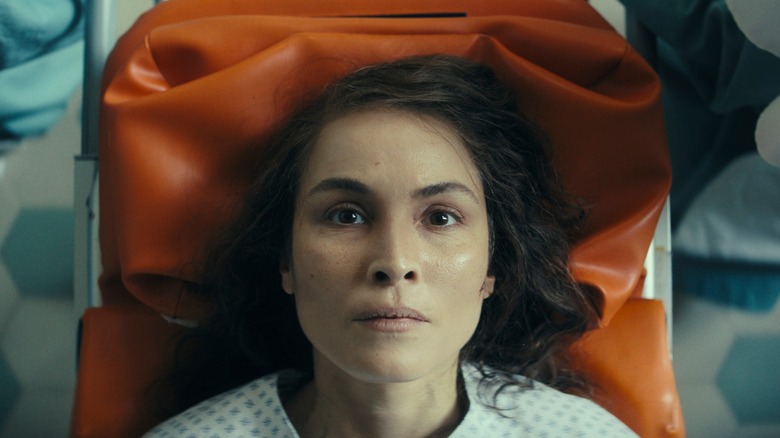 Noomi Rapace's Jo lays on a stretcher in Constellation