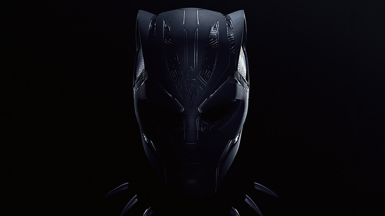 A Black Panther mask submerged in darkness