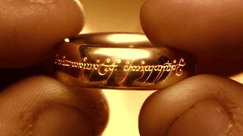 A close up of the One Ring held in hands