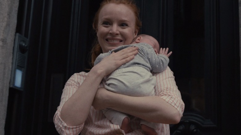 Dorothy smiles holding baby