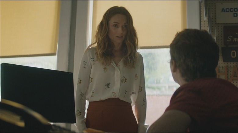 Kerry Condon stands in front of a window in Three Billboards Outside Ebbing Missouri