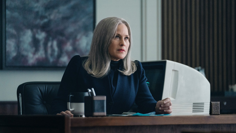 Patricia Arquette as Harmony Cobel/Mrs. Selvig sitting at her desk in Severance season 1