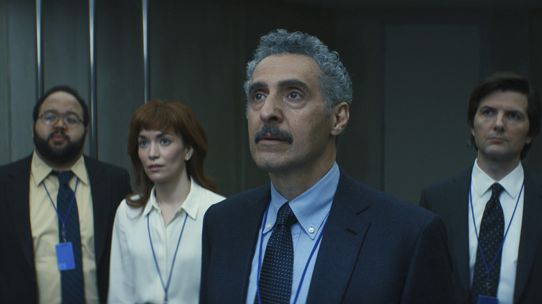 Zach Cherry as Dylan G., John Turturro as Irving B., Britt Lower as Helly R., and Adam Scott as Mark S. with concerned expressions on their faces in Severance season 1