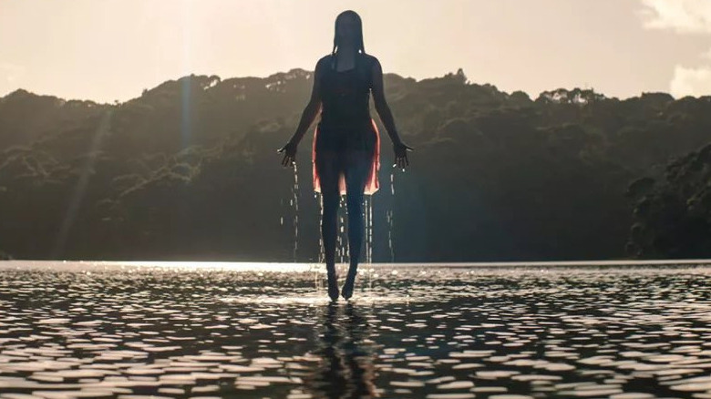 Jess floating above lake