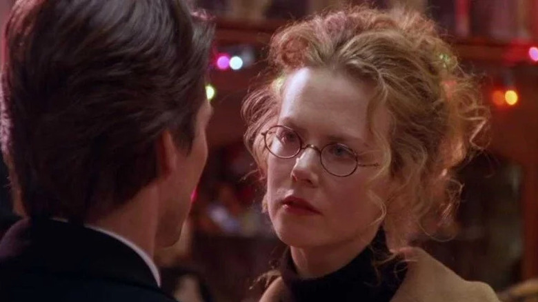 Nicole Kidman as Alice Harford stares pensively at Tom Cruise as Bill Harford in Eyes Wide Shut (1999)