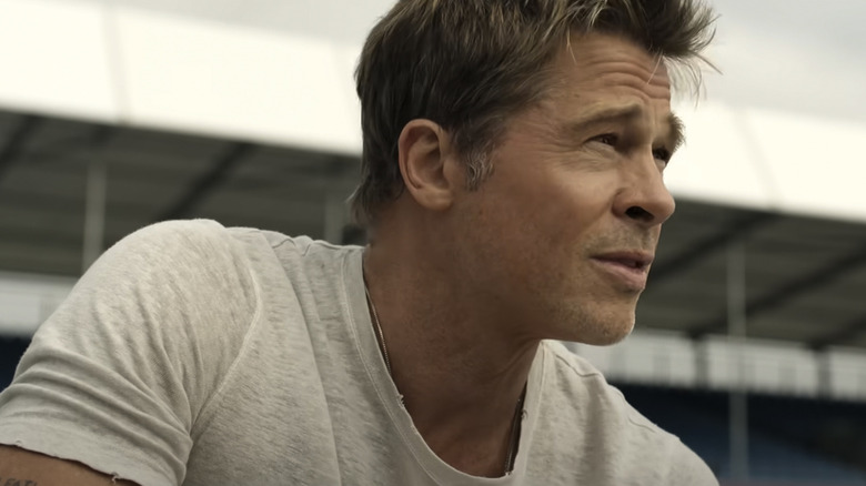 Brad Pitt's Sonny Hayes squints on the racetrack wearing a T-shirt in F1