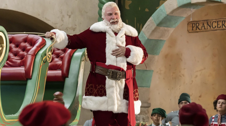 Tim Allen as Santa Clause, standing next to his sleigh in Santa's Workshop in The Santa Clauses