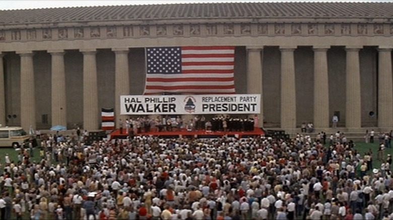 Hal Phillip Walker banner and American flag in front of crowd in Nashville