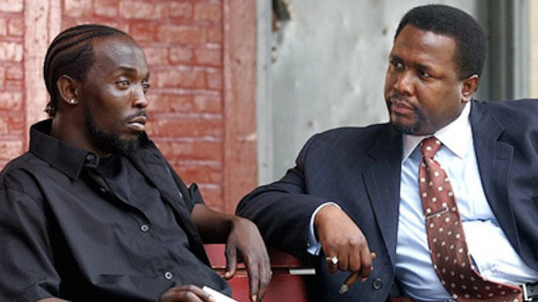 Omar Little (Michael K. Williams) and Bunk Moreland ((Wendell Pierce) sit on a bench and talk in "The Wire"