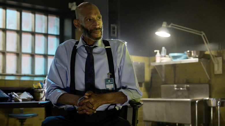 Tony Todd as William Bludworth sitting in a morgue in Final Destination Bloodlines