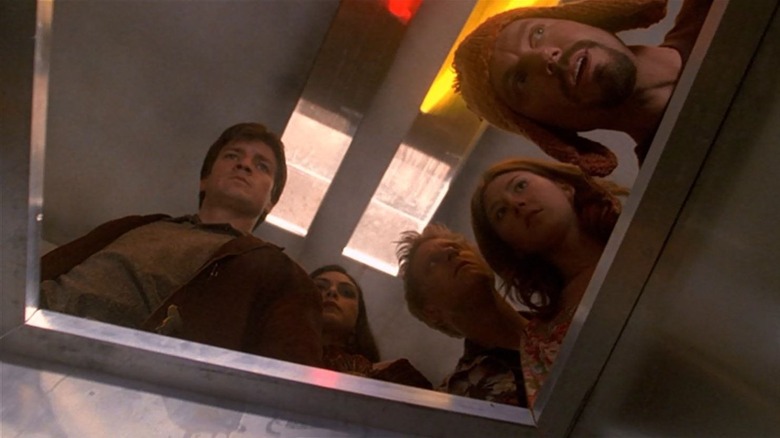 Firefly cast looking in a hole