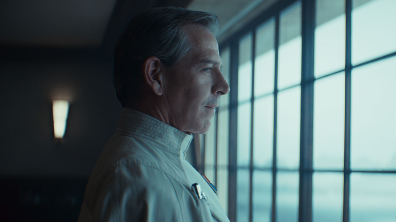 Ben Mendelsohn as Director Orson Krennic looking through a window in Andor season 2