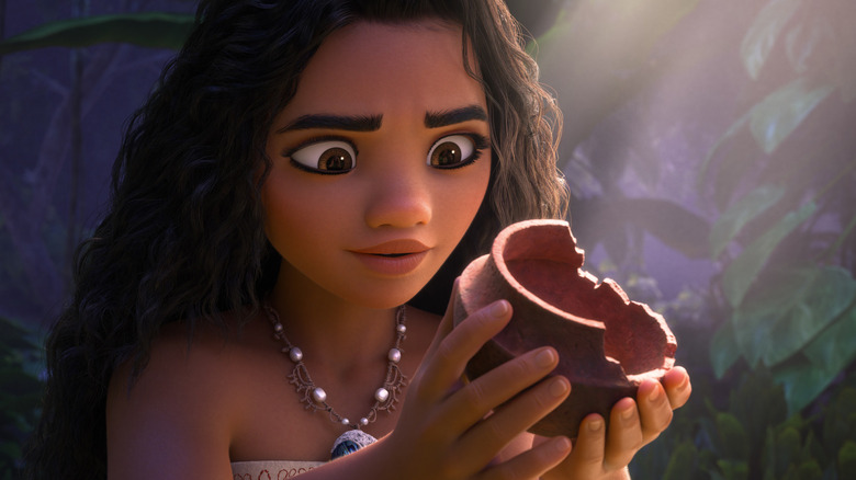 Auli'i Cravalho as Moana holding a coconut in Moana 2