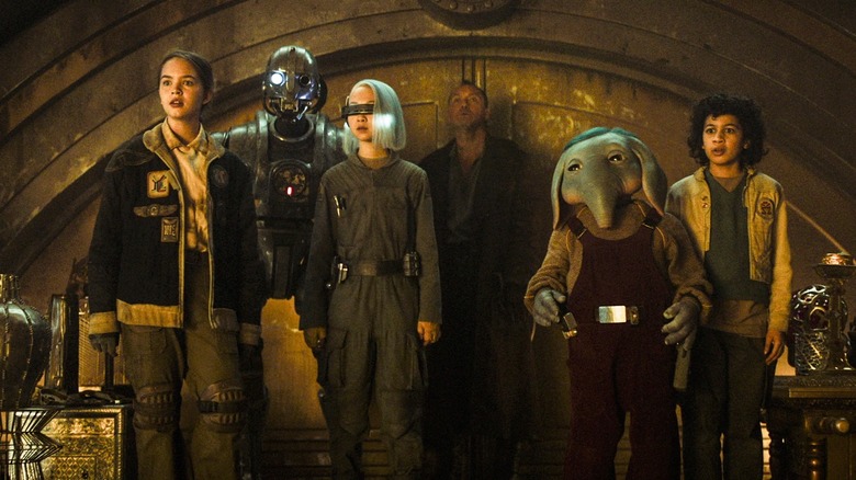 The main characters of Star Wars: Skeleton Crew standing inside a vault staring at something