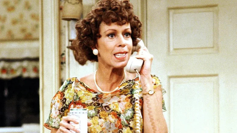 Carol Burnett holds a phone receiver