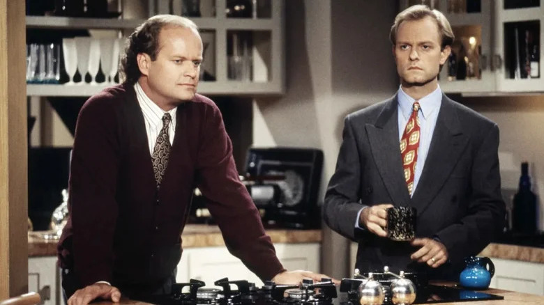 Frasier and Niles stand in Frasier's kitchen looking off into the distance