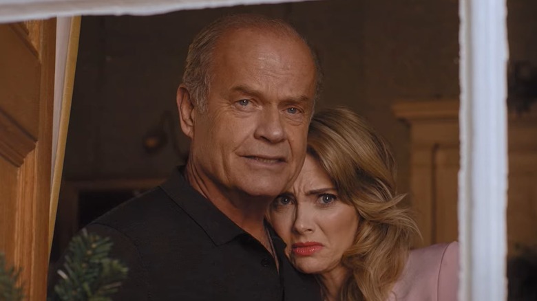 Kelsey Grammer as James and April Bowlby as Jackie looking out the window in Father Christmas is Back