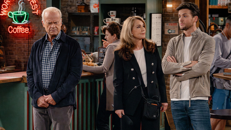 Frasier looks dejected as he stands in Cafe Nervosa alongside Roz and Freddy